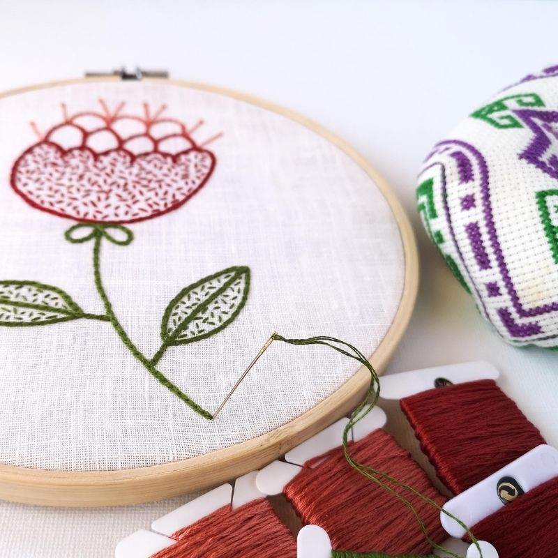 Red abstract flower embroidery in making
