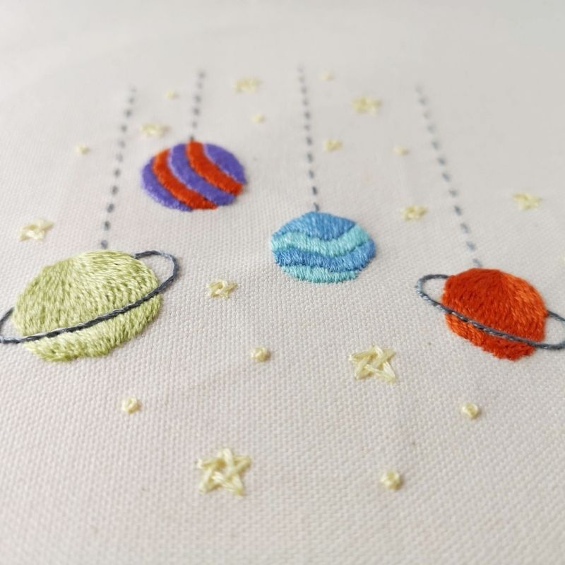 Toy Galaxy embroidery with Satin stitch on white linen