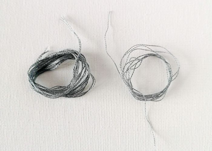 Separated strands of embroidery floss image