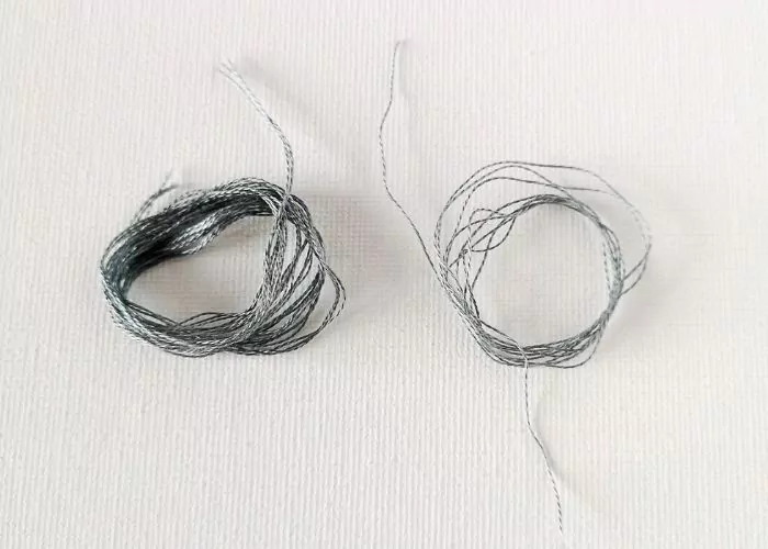 Separated strands of embroidery floss image