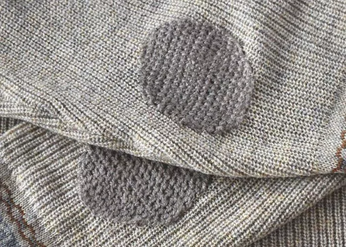 Mending knitwear: Elbows of the sweater mended with Scotch darning stitch