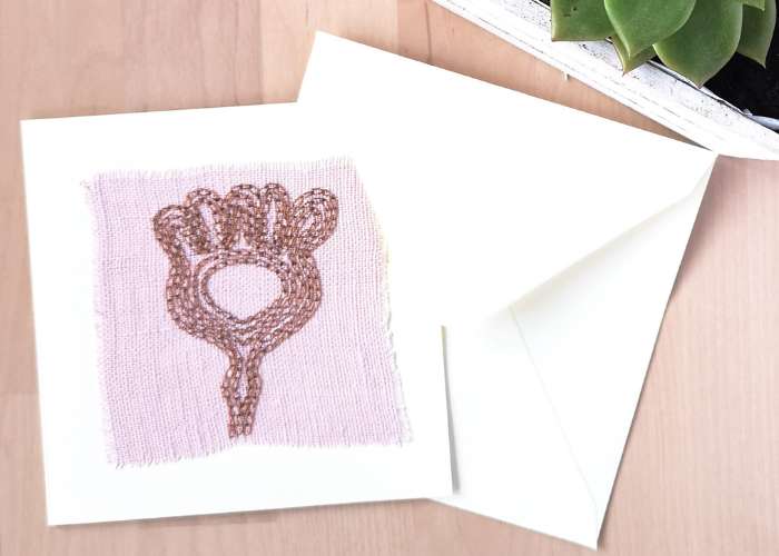 Abstract plant card hand embroidered with chain stitch on pink linen fabric