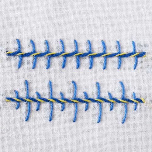 Barb stitch front side - embroidery in blue and yellow thread on white fabric