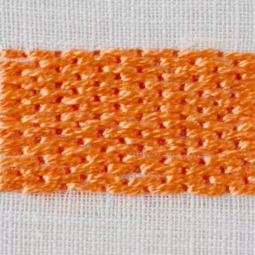 Brick stitch embroidery with orange pearl cotton on white fabric