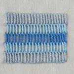 Buttonhole shading stitch in various shades of blue embroidery floss