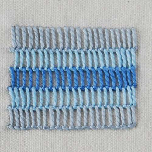 Buttonhole shading stitch in various shades of blue embroidery floss