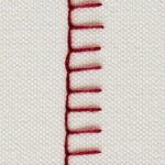 Stitch hand embroidered with dark red thread on white background