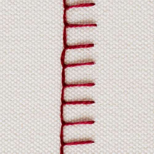 Stitch hand embroidered with dark red thread on white background