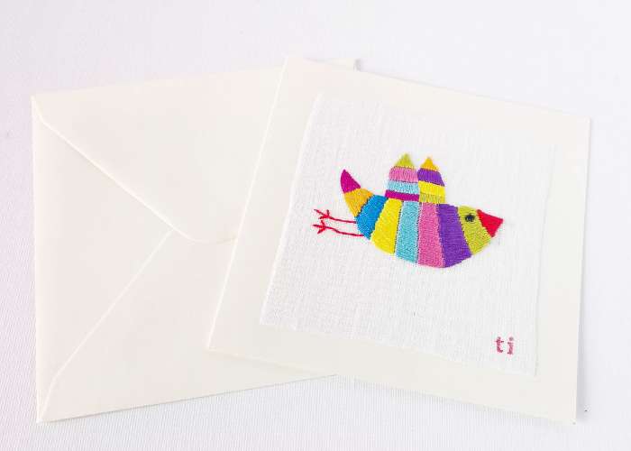 Postcard with colorful bird embroidery