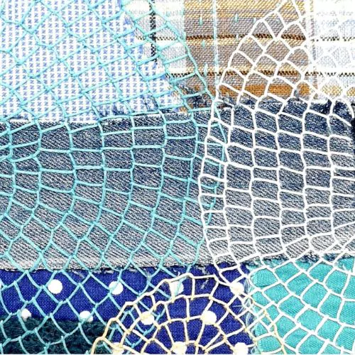 Denim fabric with blanket stitches embroidered with light-colored threads