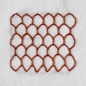 Honeycomb stitch embroidery with dark red thread on white fabric