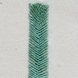 bar with green threads on white canvas