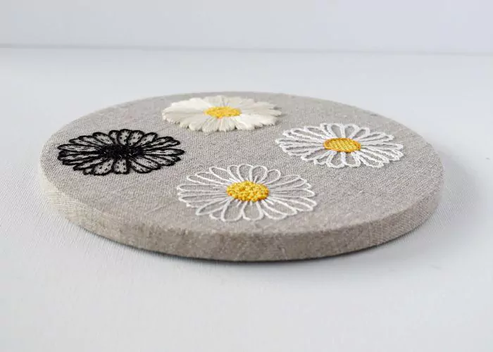 Floral embroidery on natural linen framed without outer hoop