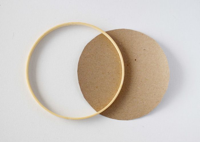 Inner hoop and round piece of brown craft paper