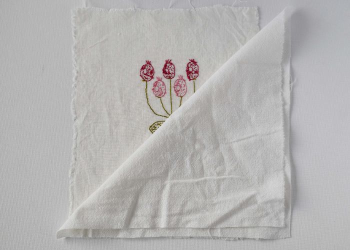 Pink floral embroidery layered with backing fabric
