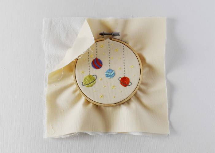 Tighten both layers of fabric in a hoop