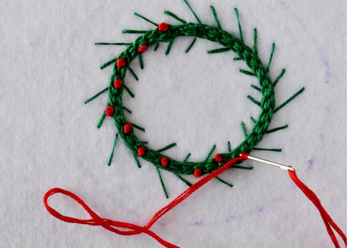 Embroider red berries with French knots