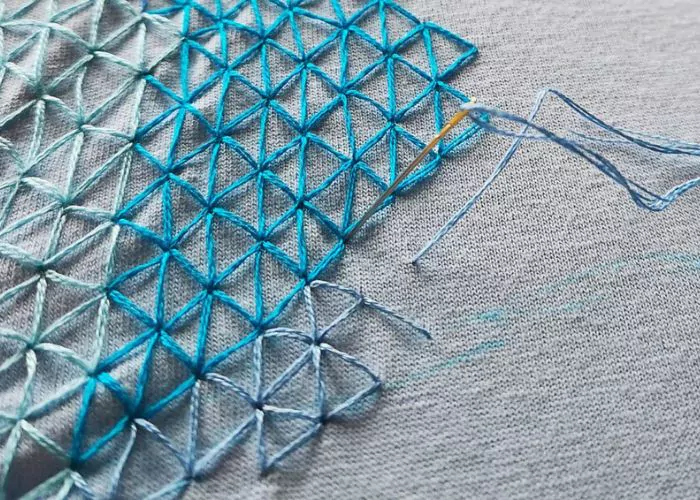 Mending stitches with blue threads in progress