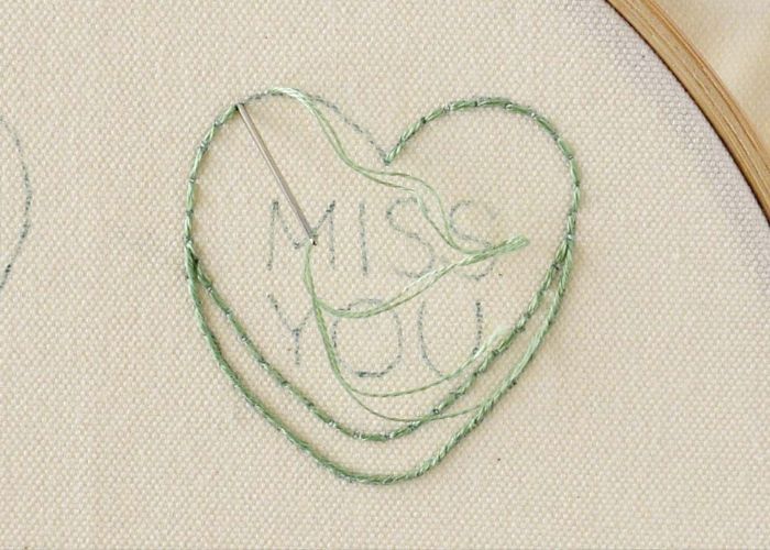 Embroider green heart outline with backstitch