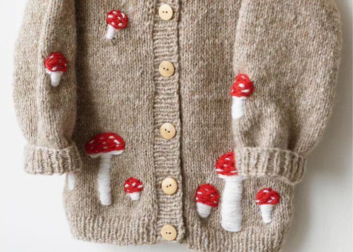 Mushroom embroidery on beige cardigan: Mending knitwear