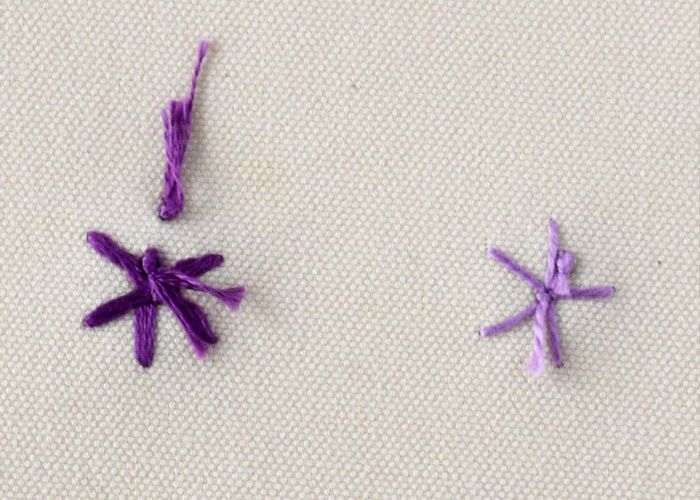 Whipped spider wheel embroidery with purple threads back side