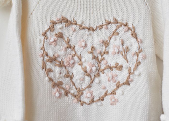 White sweater with floral heart embroidery