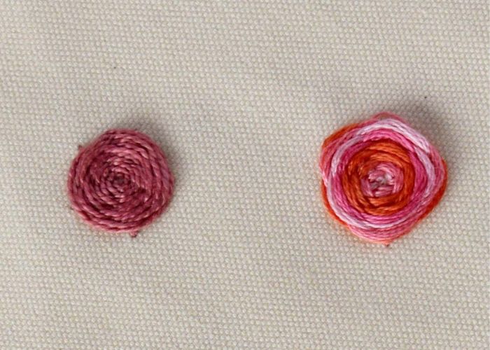 Woven spider wheel stitch flowers pink pearl cotton and variegated floss, front side