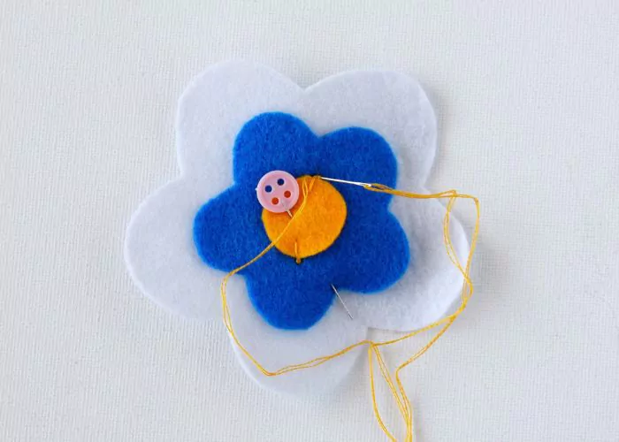 Embroider Pistil Stitch to secure the pieces of felt fabric together