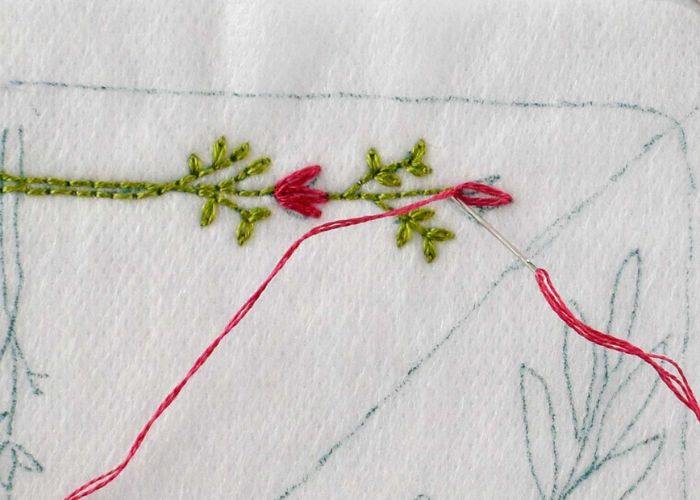 Embroider small pink flowers