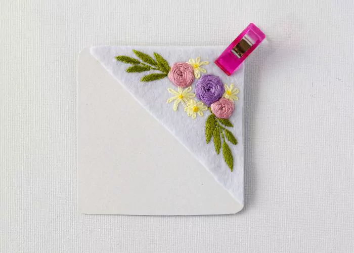 Pin floral embroidery with a card