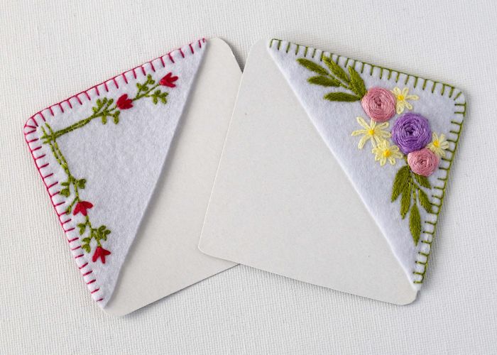 Two corner bookmarks with floral embroideries