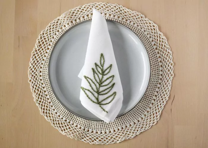 White linen napkin with olive branch embroidery