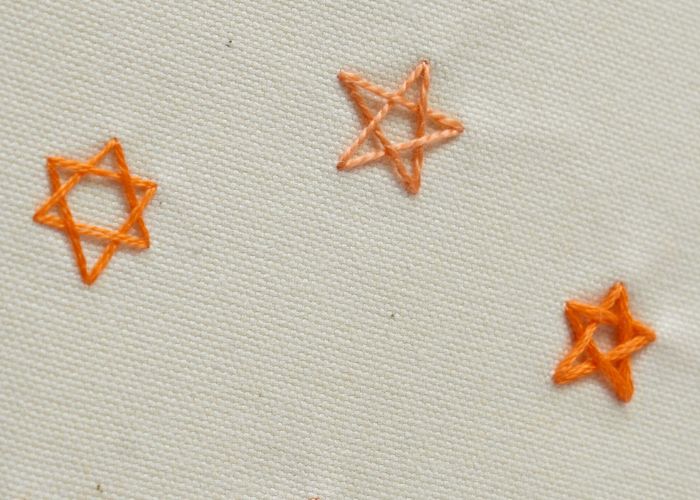 Outlined stars - Woven Star Stitch with orange floss