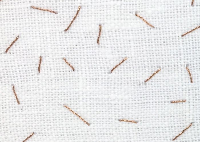 Seed stitch embroidery with metallic threads