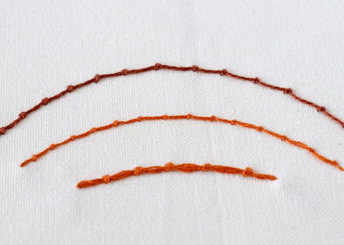 Coral Stitch embroidery. Brown pearl cotton and orange embroidery floss