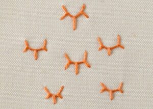 Crown Stitch embroidery with orange pearl cotton