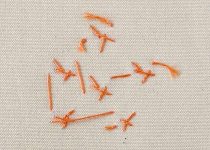 Crown Stitch-Stickerei mit orangefarbener Perlmutt-Baumwolle Rückseite