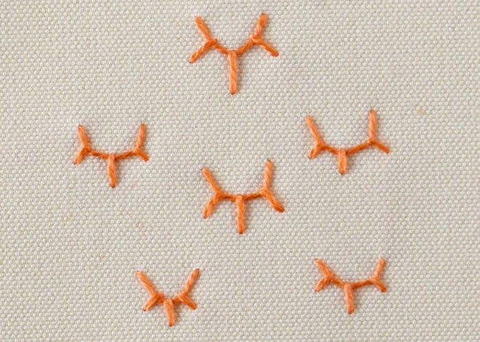 Crown Stitch embroidery with orange pearl cotton