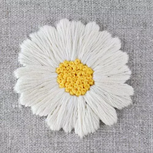 Summer embroidery patterns white Daisy wit filled center. Hand embroidery on linen