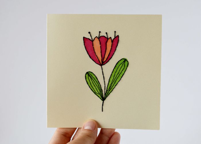 Hand embroidered card with a modern floral motif