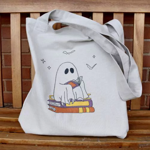 Hand embroidered tote bag with a reading ghost