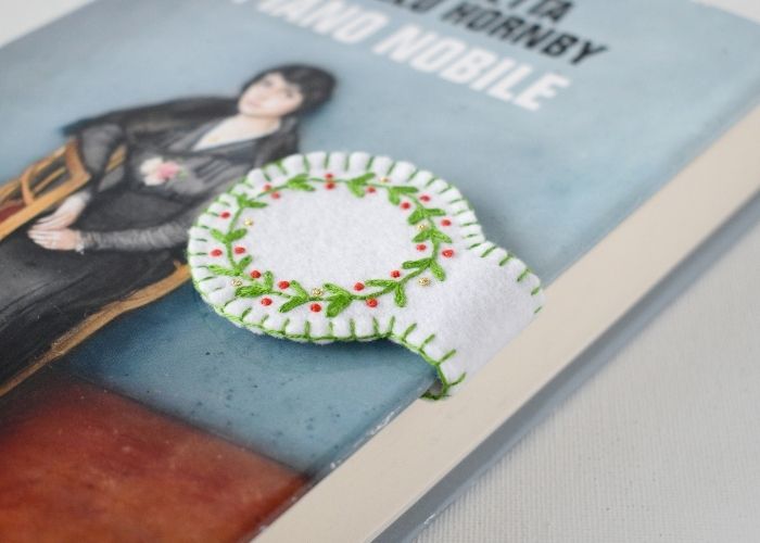 Hand embroidered magnetic bookmark in a book