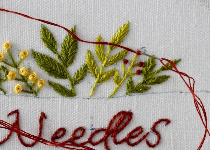 Embroider red berries with French knots