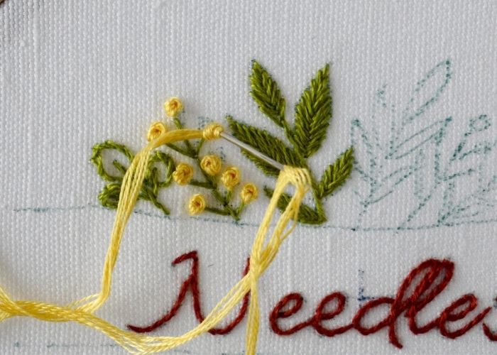 Embroider yellow berries with French knots