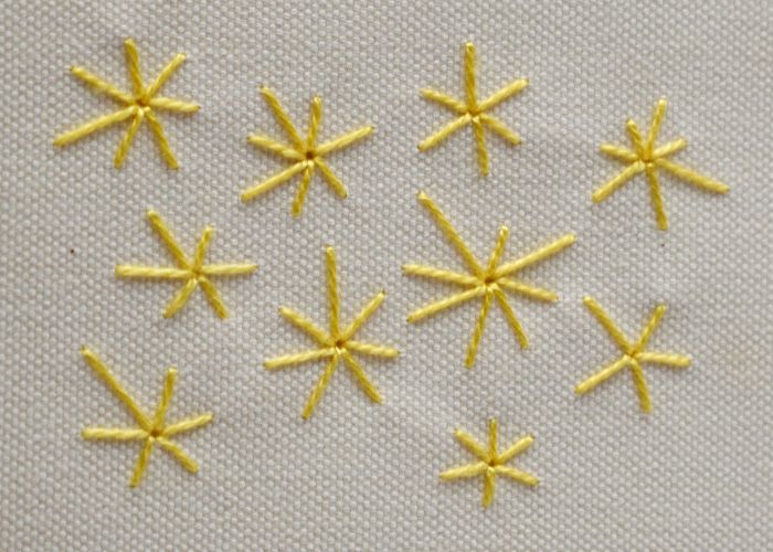 Eyelet Star Stitch embroidery with yellow pearl cotton thread