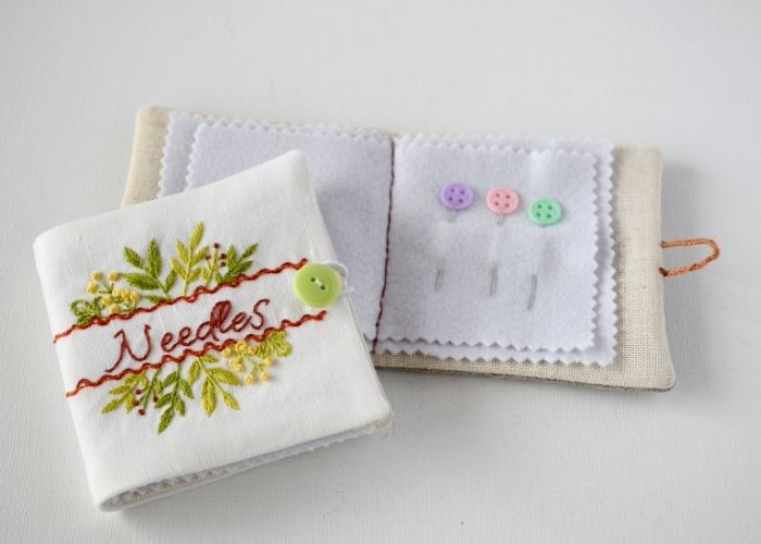 Two hand embroidered needle books