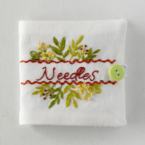 White hand embroidered needle book