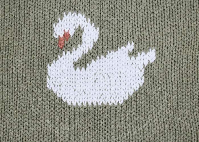 Swan embroidery with duplicate stitch on knitwear