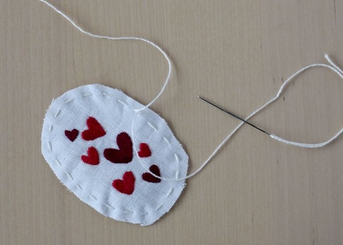 Running stitch to gather the edge of the embroidery