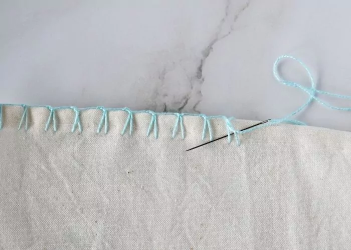 Securing the edge of the fabric with German Knotted Blanket Stitch image